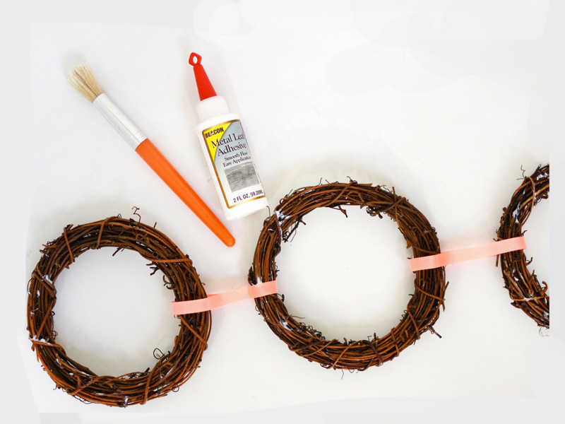 Add metal leaf adhesive to wreaths