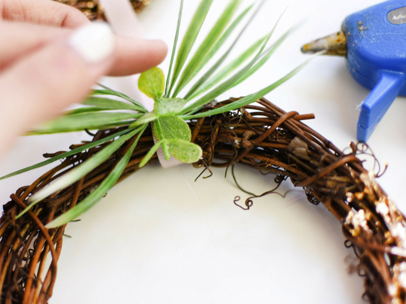 Glue greenery to wreath