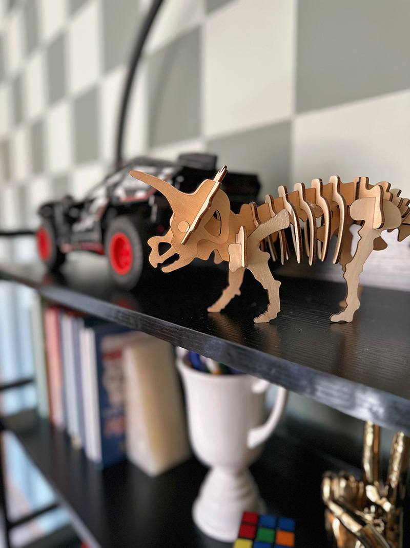 Styling an arch bookshelf with model dinosaur