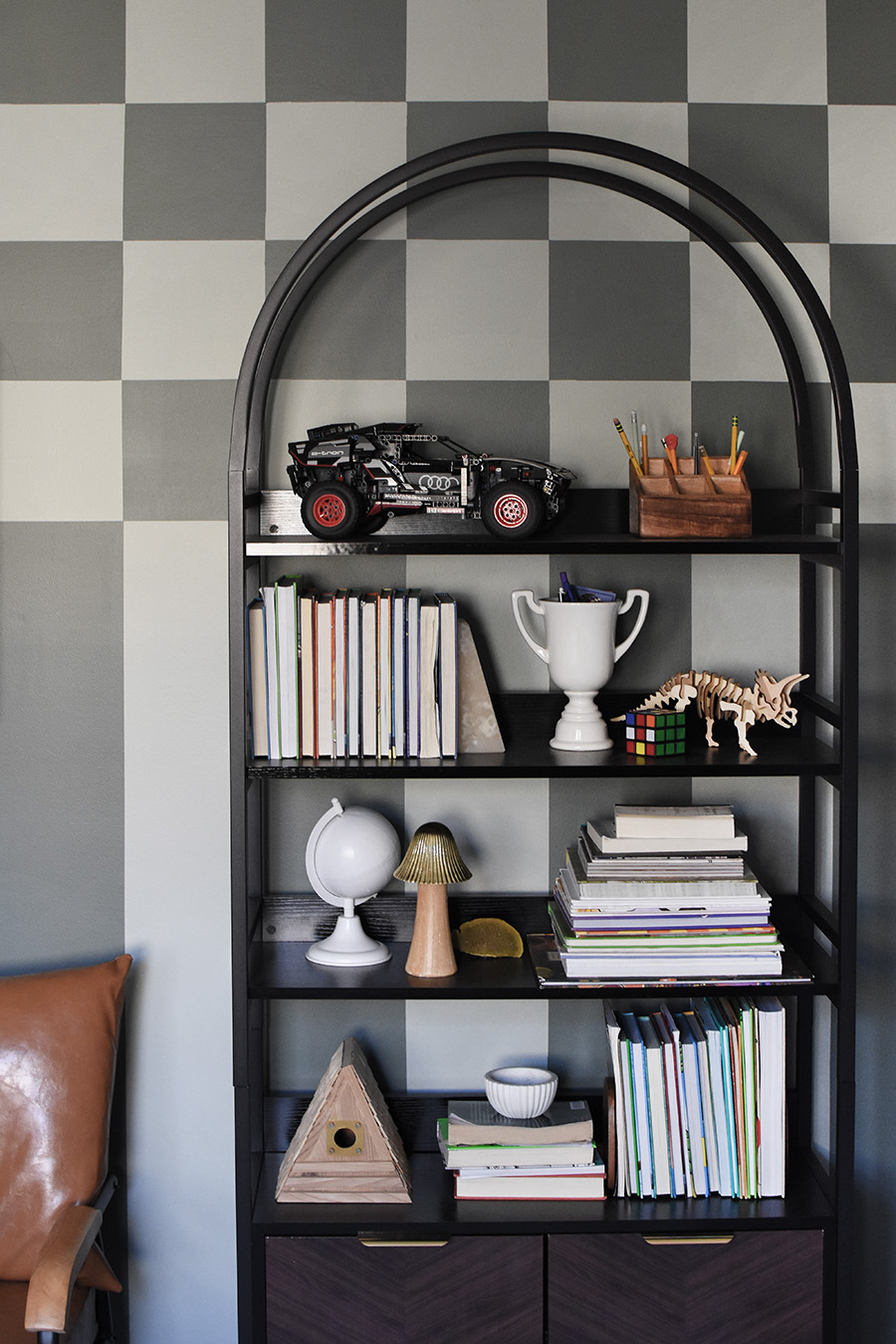 Bookcase against checkered wall