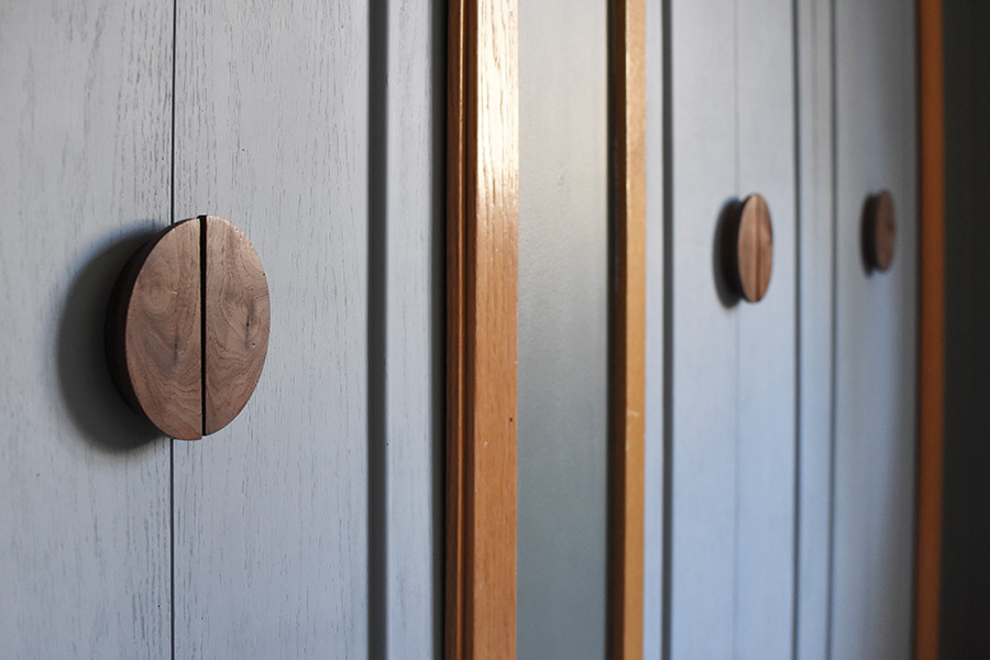 Soft Blue Closet doors with round wooden knobs