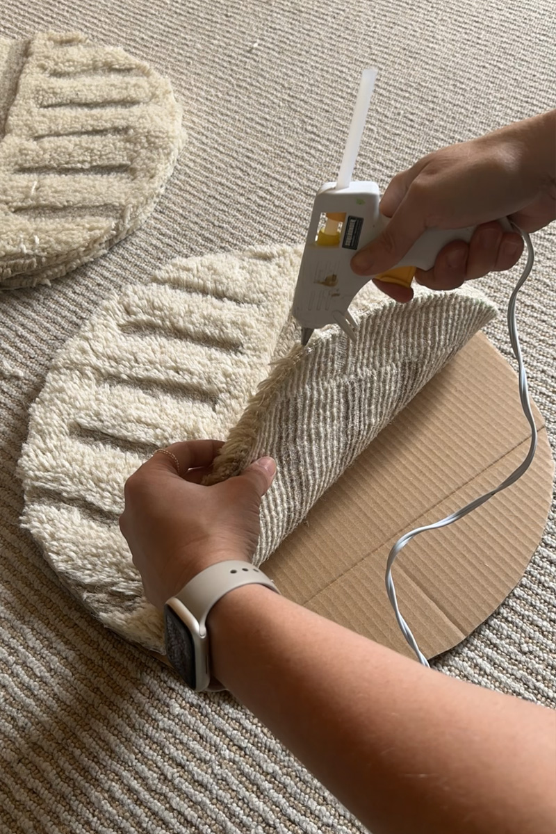 Bind fraying rug with hot glue