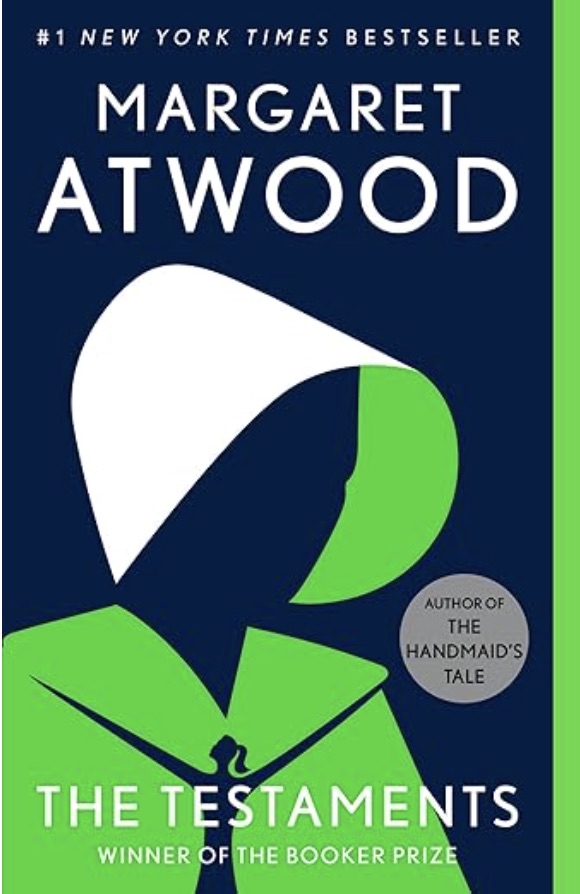 The Testaments, Blue background with a women in a white amish like hat and a green dress - Fiction book