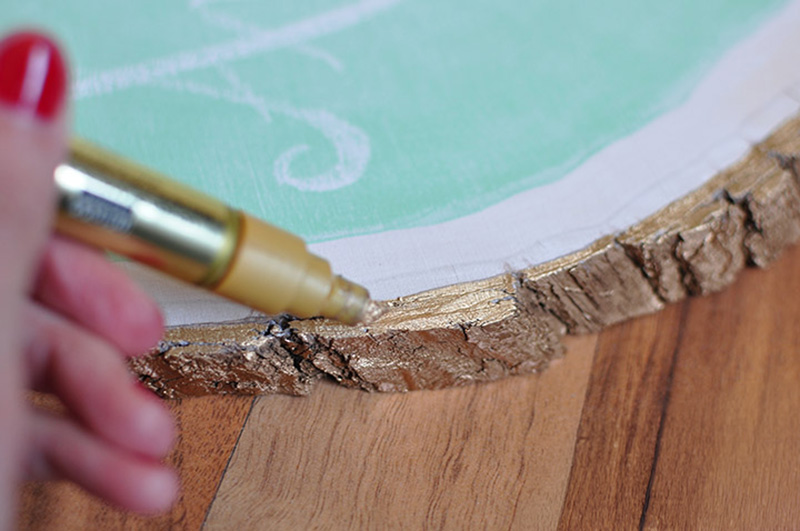 Painting a gold foil edge on a tree slice