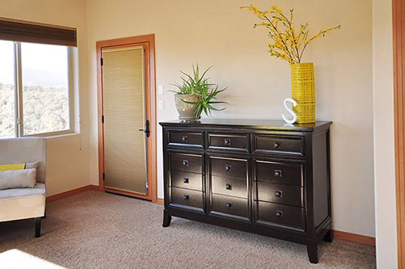 Dark wood dresser with tan bedroom walls